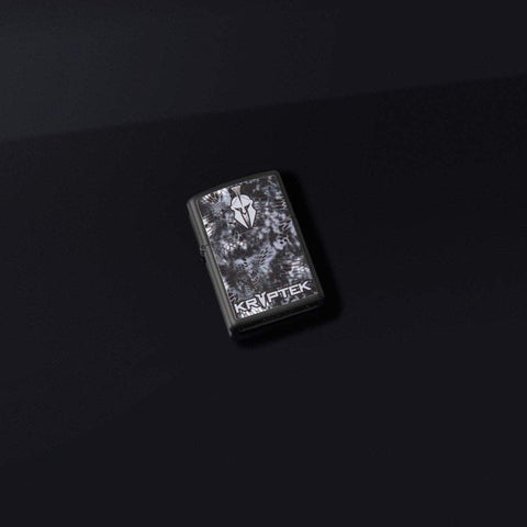 Lifestyle shot of Kryptek® Black Matte Windproof Lighter laying on a black surface