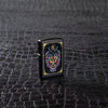 Lifestyle image of Neon Dragon Design Black Matte Windproof Lighter standing on a black scale textured surface