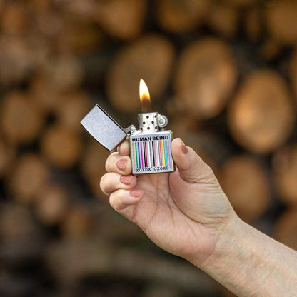 Lifestyle image with Human Being Design Street Chrome™ Windproof Lighter with its lid open and lit in hand