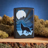 Wolf and Moon Design Windproof Lighter on tree stump with moss in background