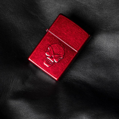 Front view of the Doom Skull Lighter laying on a leather background 