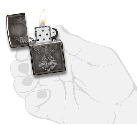 Harley-Davidson Black Ice Windproof Lighter with its lid open and lit, in hand