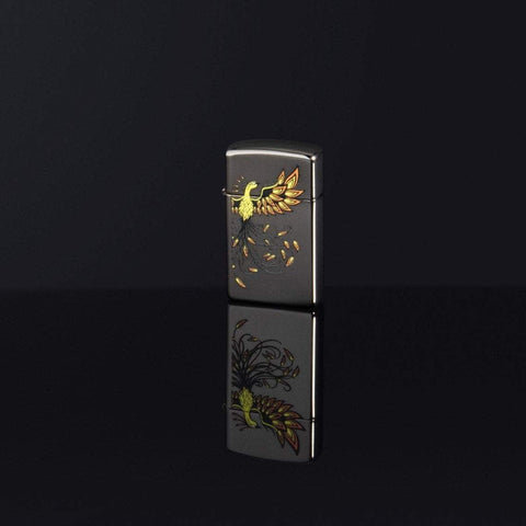 Lifestyle image of Slim® Phoenix Design Black Ice® Windproof Lighter standing on a black surface, with the design reflecting off the bottom.
