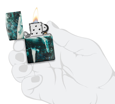 Zippo Spazuk Whale Design 540 Color Windproof Lighter lit in hand.