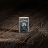Lifestyle image of Zippo Jack Daniels Street Chrome Windproof Lighter standing on a wooden table.