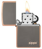 Classic Rustic Bronze Zippo Logo Windproof Lighter with its lid open and lit.