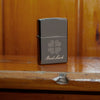 Lifestyle image of Good Luck Design Black Ice Windproof Lighter standing on a wooden banister