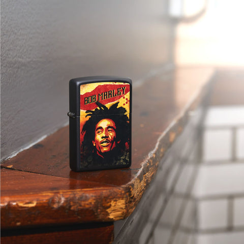 Lifestyle image of Bob Marley Illustrated Black Matte Lighter standing on wooden banister