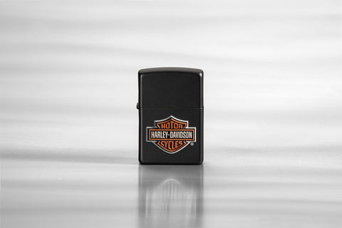 Lifestyle image of Harley-Davidson® Texture Print Classic Logo Black Matte Lighter, standing on a sheet of metal