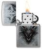 Zippo Dragon Design Linen Weave Windproof Lighter with its lid open and lit.
